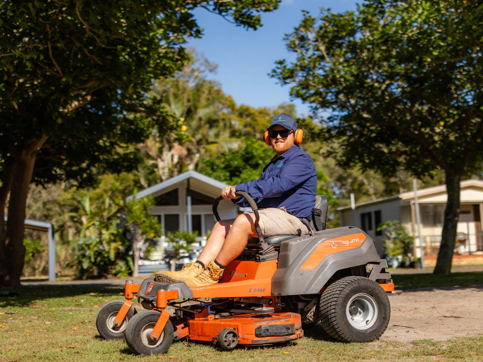 A Hampshire team member mowing the lawn at a park